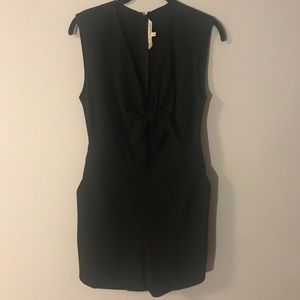 Black romper. Low cut with bow in the front.